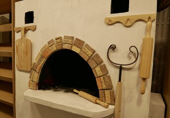 Traditional Russian white oven in the interior. Stone hearth and objects of village life. Ancient cooking technologies.