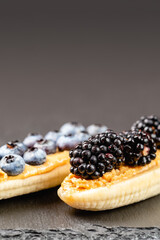 Bananas with peanut butter and berries on the top