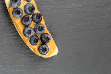 Bananas with peanut butter and berries on the top