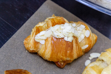 Freshly baked flavored with white chocolate and nuts croissant. Sweet handmade dessert with almond