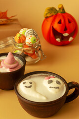 A mug of coffee, cocoa with marshmallows . Serving dessert for Halloween. Festive concept