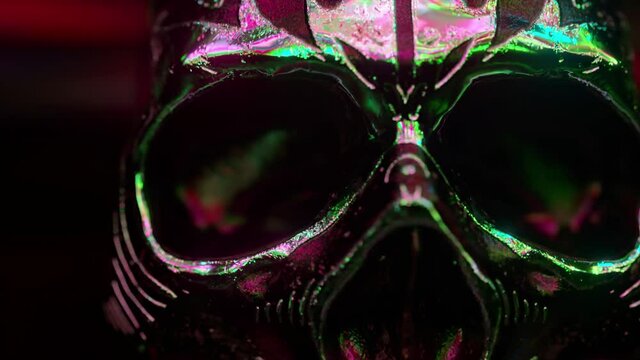 Human skull with gold accents close-up. Horror and halloween fear concept. Neon light. 3d animation
