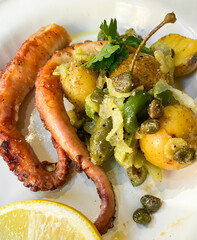 Grilled octopus with potatoes. Selective focus. Mediterranean cuisine.