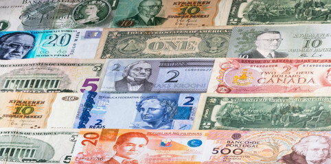 Colorful background with current and old banknotes from some countries.