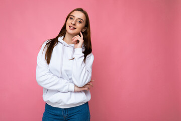 Photo of beautiful positive smiling adult woman wearing stylish clothes standing isolated on colorful background with copy space looking at camera
