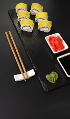 Sushi selection on black slate, food border background
