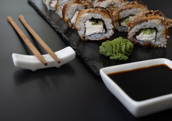 Sushi selection on black slate, food border background