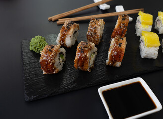 Sushi selection on black slate, food border background