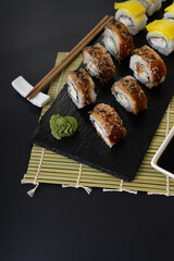 Sushi selection on black slate, food border background