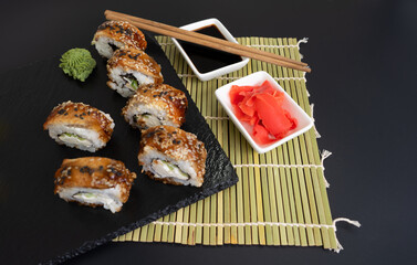 Sushi selection on black slate, food border background
