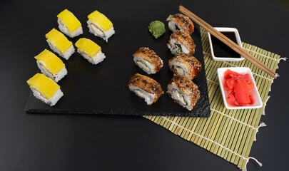 Sushi selection on black slate, food border background
