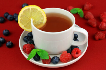cup of tea with berries and mint