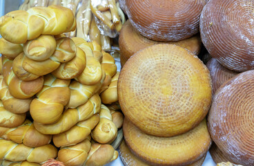 Brown and yellow round cheese and cheese cornrows on the counter magazine.