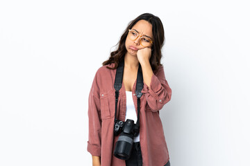 Young photographer woman over isolated white background with tired and bored expression