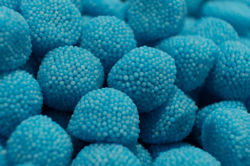 Sweet jelly look like blue raspberry and candies with sugar. Macro.