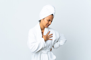 Young woman in bathrobe over isolated white background having a pain in the heart