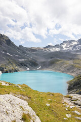 Amazing hiking day in one of the most beautiful area in Switzerland called Pizol in the canton of Saint Gallen. A wonderful view at the alpine lake called Wildsee with a tent by the lake. Epic view.