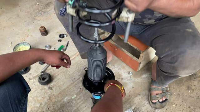 Coil spring and hydraulic shocker  fixing by mechanic