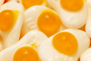 Sweet jelly like a scrambled eggs and candies with sugar. Macro.