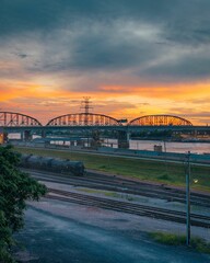 Obraz premium Sunset over railroad tracks and the Mississippi River, in East St. Louis, Illinois