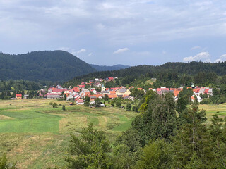 Fototapeta na wymiar View of the settlement Lokve and the forest area of Gorski kotar - Croatia (Pogled na naselje Lokve i šumsko područje Gorskog kotara - Hrvatska)