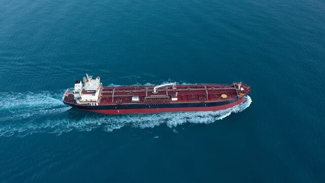 A petroleum tanker underway open sea. Supertanker loaded with full of oil, ploughs through the water. Aerial tracking shot of a 182 meters long oil chemical tanker ship
