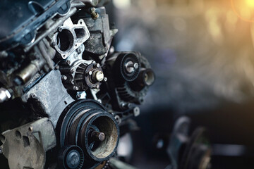 Fototapeta na wymiar car engine repair in a car service, removed engine, crankshaft pulleys