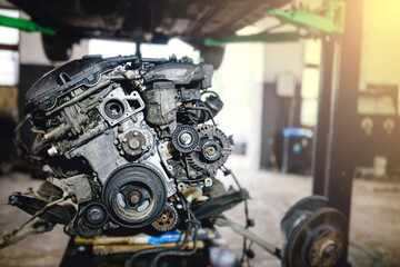 Fototapeta na wymiar car engine repair in a car service, removed engine, crankshaft pulleys