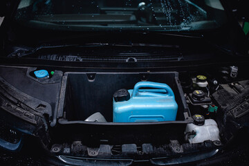 fuel canister in the trunk of an electric hybrid vehicle car