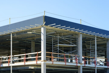 unfinished metal frame of a new modern industrial building with utilities