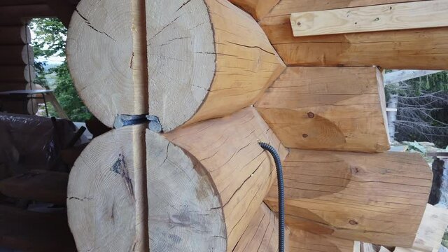 Part of the structure of a wooden house, details of a truss wooden structure, a house from a log house