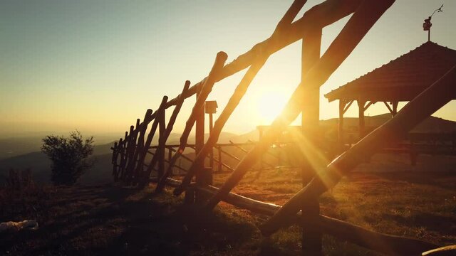 Sunset view over house wooden fence in a mountain valley