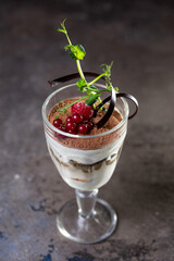 tiramisu dessert in a glass with berries.