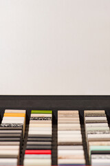 Large selection of stone samples for countertops and floors. Pieces of artificial acrylic stone in...