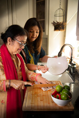 Daughter teaching mother cooking hack  © Simi Jois