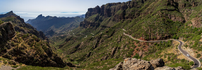 Panoramic view on the Macizo de Teno mountains, Masca Gorge with mountain road to the village of Maska. View from the observation deck - Mirador De Masca. Tenerife. Canary Islands. Spain. - obrazy, fototapety, plakaty