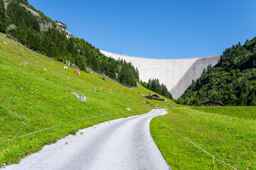 Huge concrete apline dam on sunny summer day. Zillergrundl Speicher, Zillertal Alps, Austria