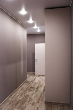 Spacious entrance hall in the apartment with built-in wardrobe and mirrors