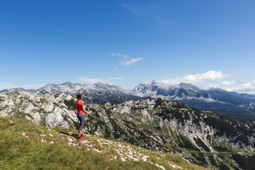 Fototapeta premium Woman enjoying an amazing view of mountain peaks