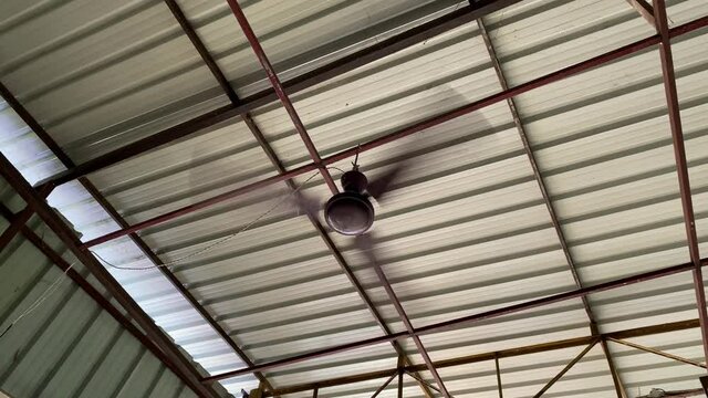 A high speed fan is running on the roof with white background