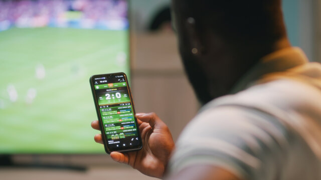 African American fan placing online stakes and speaking