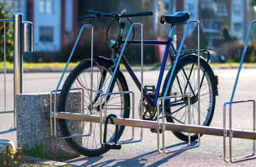 Bicycle in town at a bicycle rack.