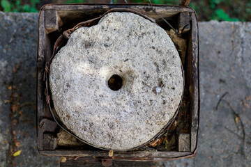 Millstones of an old retro vintage hand mill. Background with copy space for text - obrazy, fototapety, plakaty