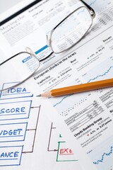 Obraz premium Glasses and Pencil on Business Sheets Close-Up