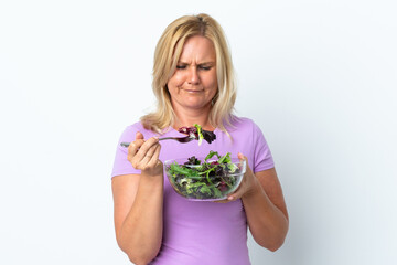 Middle age Lithuanian woman isolated on white background holding a bowl of salad with sad expression