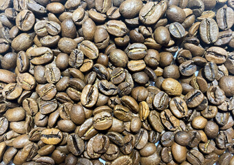 Background of Arabica coffee beans in close-up. Coffee bean texture