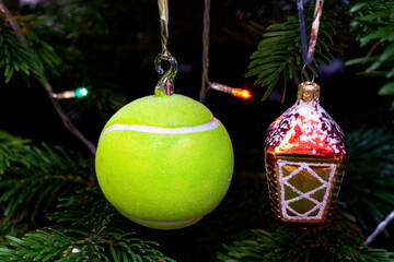 Christmas tree decoration in the form of tennis ball. Close-up, selective focus