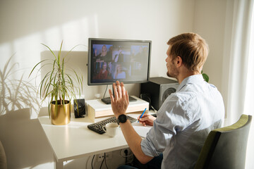 Work from home. Young man having video call via a computer in the office. Stay at home and working...