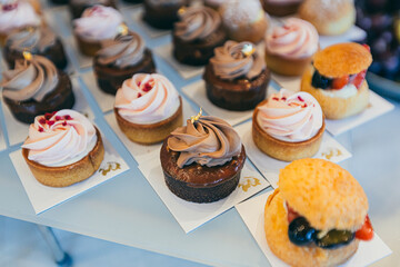 Festive buffet table with delicious desserts of different colors at the wedding ceremony