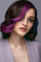 Naklejka premium Beautiful woman with multi-colored hair and classic make up and hairstyle. Beauty face.